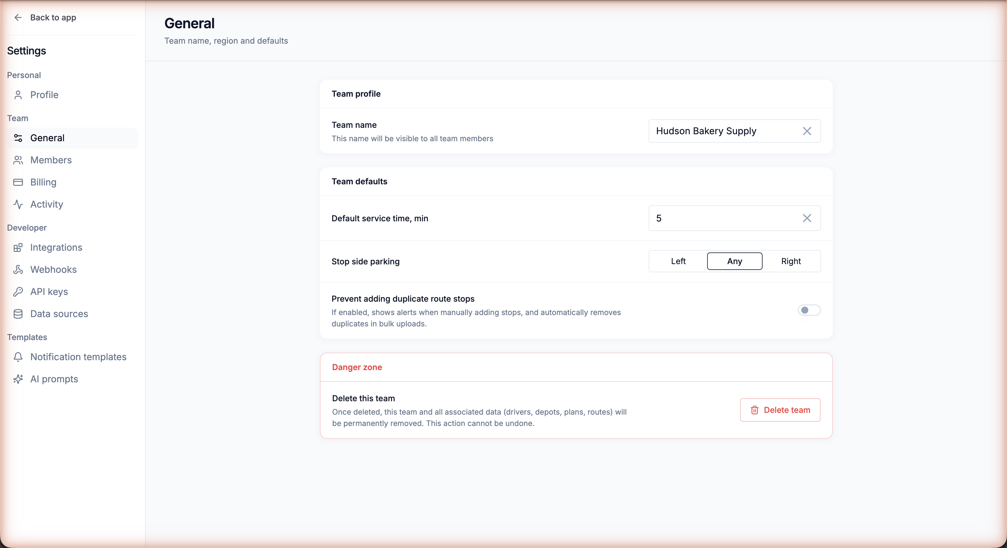 Settings → Team → General with the Team defaults card — service time, stop side parking, duplicate prevention